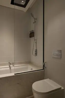 a bathroom with a shower and a toilet and a tub at Elegant Luxury Living in Palace Residences in Dubai