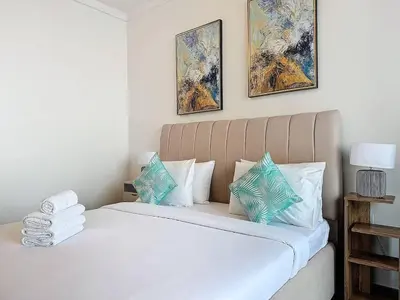 a bedroom with a bed with white and blue pillows at FAM Living - Spacious 3-Bedroom Apartment in Creek Gate with Stunning Views in Dubai
