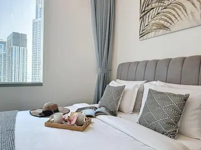 a bedroom with a bed with a view of a city at FAM Living - Spacious 3-Bedroom Apartment in Creek Gate with Stunning Views in Dubai