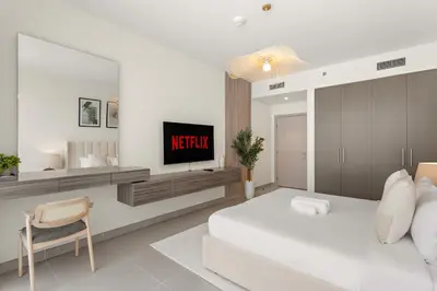 a bedroom with a bed and a tv in it at Superb 1Bed With Pool & Gym near the Burj Khalifa in Dubai