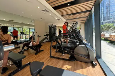 a gym with people exercising on machines in a building at Superb 1BR Apartment in the Heart of Business Bay in Dubai