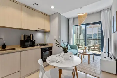 a kitchen with a table and a kitchen with a view at Superb 1BR Apartment in the Heart of Business Bay in Dubai