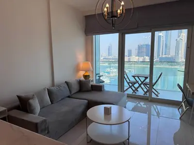 a living room with a couch and a table at 2 Bed - Sunrise Bay Views in Dubai