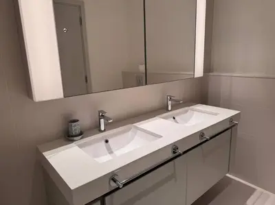 a bathroom with a white sink and a mirror at 2 Bed - Sunrise Bay Views in Dubai