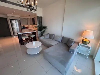 a living room with a couch and a table at 2 Bed - Sunrise Bay Views in Dubai