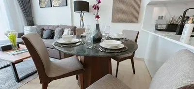 a dining room table with plates and glasses on it at Comfortable 1br Stay In Jvc Parking & Pool in Dubai