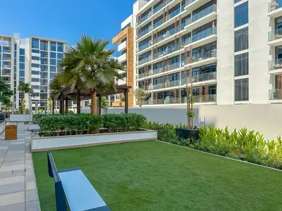 a garden with a bench and a gazebo at Royalton - Serene Studio Apt in the Heart of Meydan District in Dubai