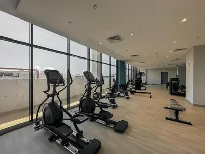 a gym with a bunch of exercise equipment in a building at Royalton - Serene Studio Apt in the Heart of Meydan District in Dubai