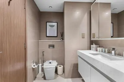 a bathroom with a toilet and a sink at Full Fountain and Burj View - 3BR Burj Royale in Dubai