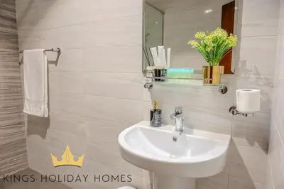 a bathroom with a sink and a mirror at Royal suites Dunya tower Burj Khalifa St Kings in Dubai