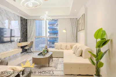a living room with a white couch and a table at Royal suites Dunya tower Burj Khalifa St Kings in Dubai