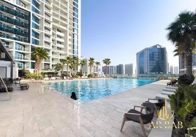 a swimming pool in the middle of a city with buildings at Damac Maison Prive - Luxury Studio - Burj Khalifa View in Dubai