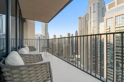 a balcony with two chairs and a view of a city at FIRST CLASS 4BR Spacious Luxury Retreat in Dubai