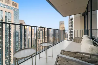a balcony with two tables and chairs on a building at FIRST CLASS 4BR Spacious Luxury Retreat in Dubai