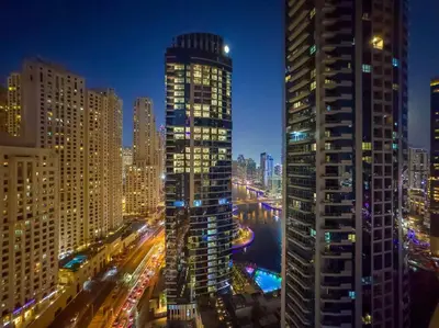 a view of a city at night with buildings at FIRST CLASS Studio Cozy Urban Retreat in Dubai