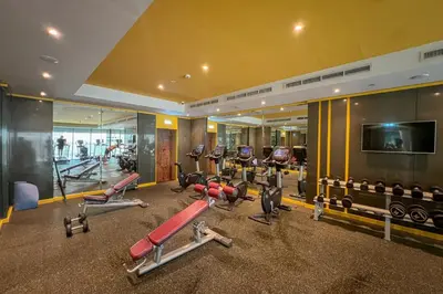 a gym with a lot of treadmills and machines at Lavish Apartment in Dubai in Dubai