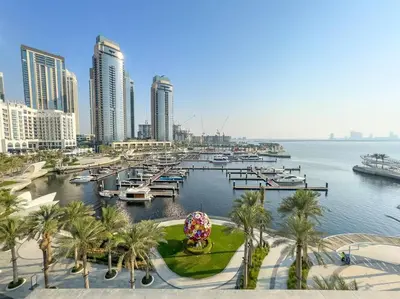 a marina with boats and palm trees and buildings at FIRST CLASS 1BR Urban Chic Oasis in Dubai