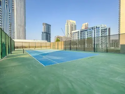 a tennis court in the middle of a city at FIRST CLASS 1BR Urban Chic Oasis in Dubai
