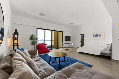 a living room with a couch and a bed at Full Sea View - Spacious & Newly Renovated Studio in JBR in Dubai