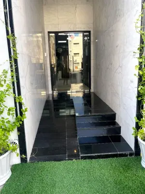 a hallway of a building with stairs and plants at Ista Vacation Homes Rental LLC KARAMA in Dubai