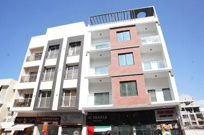 a tall white building with a brick at Ista Vacation Homes Rental LLC KARAMA in Dubai