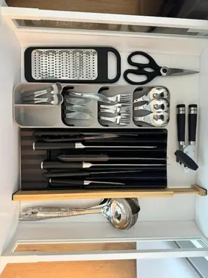 a drawer filled with knives and other kitchen utensils at Brand New Studio - Comfy & WFH in Dubai