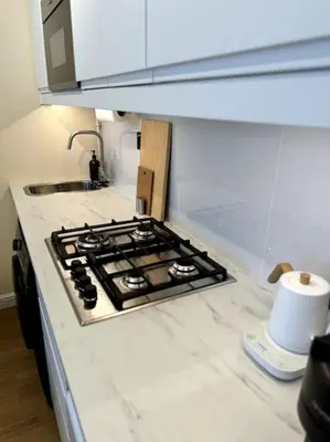a kitchen counter top with a stove top oven at Brand New Studio - Comfy & WFH in Dubai