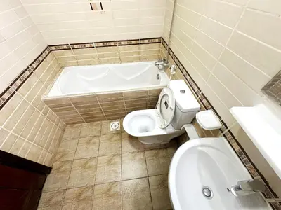 a bathroom with a toilet and a bath tub at Atelier Partition Room in Tecom Near Internet City Metro in Dubai