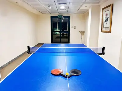 a blue ping pong table in a room at Atelier Partition Room in Tecom Near Internet City Metro in Dubai