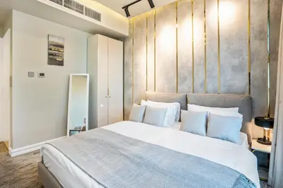 a bedroom with a large bed with white pillows at Elite Waterfront 3BR Haven - Marina and Sea Views! in Dubai