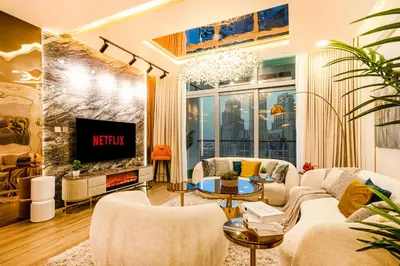 a living room with a couch and a tv at Elite Waterfront 3BR Haven - Marina and Sea Views! in Dubai