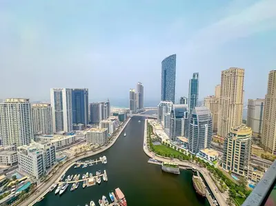 a view of a river in a city with buildings at Top-Notch 3BR in Stella Maris Tower in Dubai Marina in Dubai