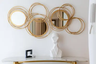 a group of mirrors on a wall above a table at Top-Notch 3BR in Stella Maris Tower in Dubai Marina in Dubai