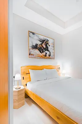 a bedroom with a bed and a painting on the wall at High rise studio near Dubai Mall in Dubai