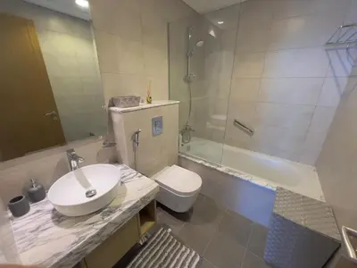 a bathroom with a sink and a toilet and a shower at 2 bedroom in Downtown Dubai in Dubai