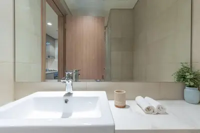 a bathroom with a white sink and a mirror at Cozy Studio in Azizi Riviera - Dubai in Dubai