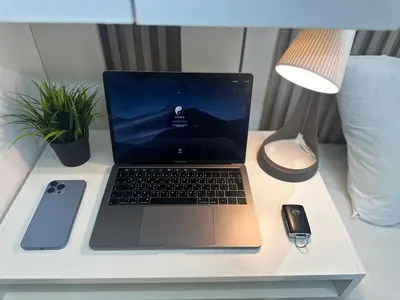 a laptop computer sitting on top of a desk with a mouse at Wanderlust Partiton Room in Tecom Near Internet City Metro in Dubai