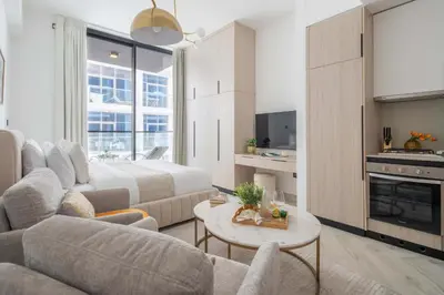a living room with a couch and a bed and a table at Frank Porter - Empire Residences in Dubai