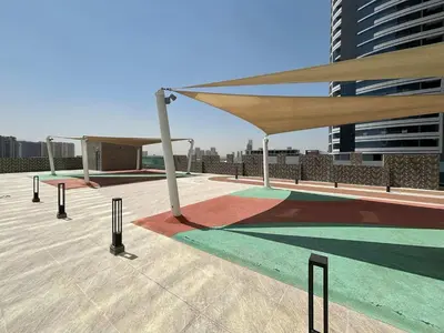 a patio with awning on top of a building at Frank Porter - Square Tower in Dubai
