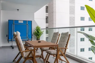 a balcony with a wooden table and chairs at Luxury Palm with Billiard, PingPong table and Beach for 4 in Dubai