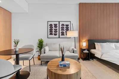 a living room with a bed and a coffee table at Waves - Chic High-Floor Studio Retreat with Canal Views in Dubai