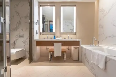 a bathroom with two sinks and a tub and a mirror at The Address Residences Dubai Opera, Full Burj Khalifa View, 2BR Downtown Luxury in Dubai