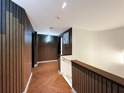 a hallway with wood paneled walls and a staircase at 3-BDR Marina Gem w Stunning Yacht Bay Views in Dubai