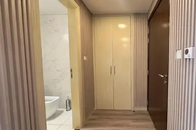 a bathroom with a tub and a toilet and a sink at Elegant 1BR Midtown Near City Center Meaisem by Vibel in Dubai