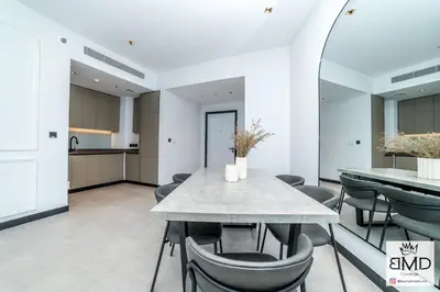 a dining room with a table and chairs at Mordern Burj khalifa View 2bd in Dubai