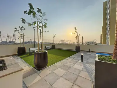 a rooftop patio with trees and grass on a building at Azizi Riviera 29 - Aesthetic Studio in Meydan in Dubai