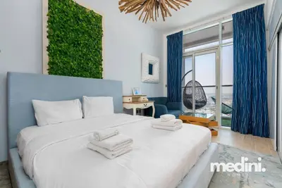 a bedroom with a large bed with towels on it at Studio One - Dubai Marina - Pool, Sauna, Hammam and Gym in Dubai