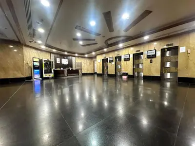 a large empty hall with doors and ailed floor at Explorer Partition Room with window Near Internet City in Dubai