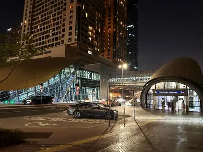 a car parked in a parking lot in a city at night at Explorer Partition Room with window Near Internet City in Dubai