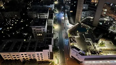 an aerial view of a city at night at Explorer Partition Room with window Near Internet City in Dubai